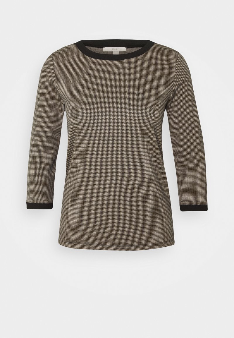 Chemise à manches longues à motif noir et beige avec un col rond et des bordures noires au niveau du col et des manches. Tissu texturé.