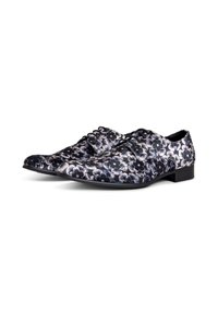 Bloemmotief jurkshoes in zwart en wit met een gladde textuur; heeft een vetersluiting en een lage, stevige hak.