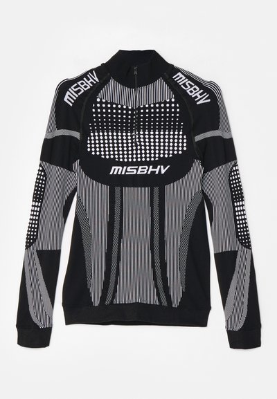 Dugi rukav sportski top u crnoj boji s bijelim prugama i točkicama, pola patent zatvarača, i MISBHV logom na ovratniku i prsima.