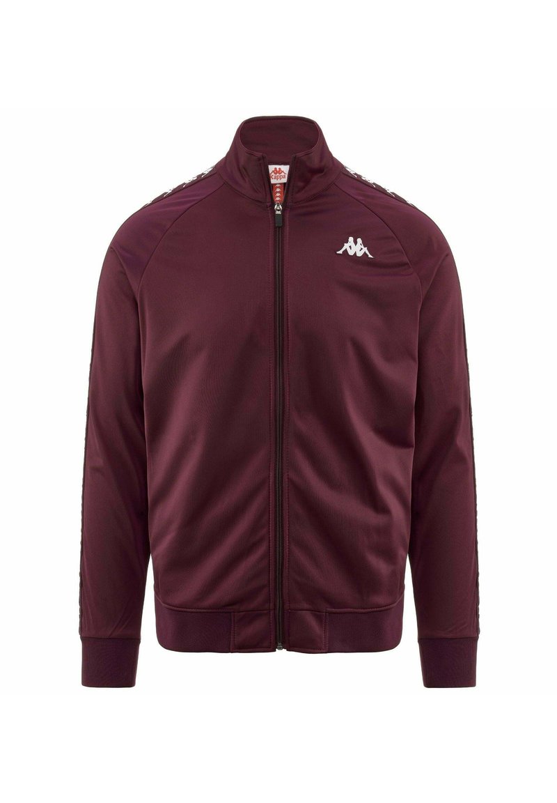 Giacca sportiva bordeaux con colletto alto, chiusura con zip, polsini a costine e dettagli laterali a strisce bianche. Realizzata in tessuto liscio e leggero.