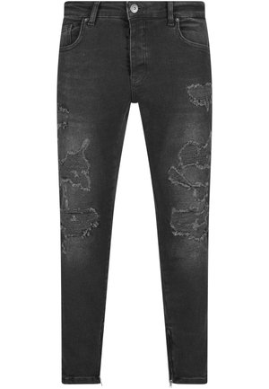 Černé džínové kalhoty s poškozenými oblastmi a roztrhanými detaily. Slim fit, s předními a zadními kapsami a zipy na kotnících.