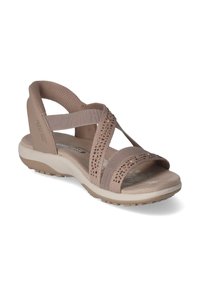 Beige dames sandaal met kruisbandjes, geperforeerde details, gevoerde voetbed en rubberen zool voor grip. Lichtgewicht en flexibel ontwerp.