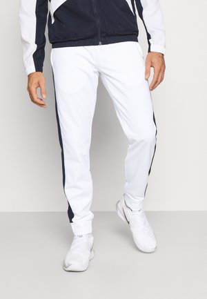 Weiße Sporthose mit navyfarbenen Seitenstreifen, aus glattem Polyester gefertigt. Hat eine schlanke Passform und einen elastischen Taillenbund mit Bündchen an den Knöcheln.