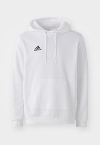 Sweatshirt à capuche blanche en tissu doux, avec une poche avant et un logo Adidas noir sur la partie gauche de la poitrine.