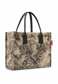 Borsa a tracolla beige con motivo ad albero nero, forma rettangolare, solide maniglie nere, superficie texture e etichetta rossa del brand sul lato.