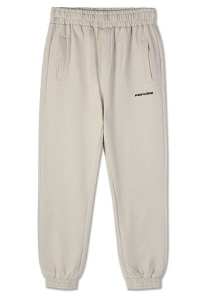 Beige sweatpants with elastic waistband and cuffs, featuring two side pockets and a black "PEGADOR" logo on the left thigh.