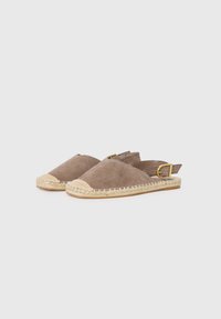 Espadrile slip-on din suede, de culoare maronie, având o branț din iută împletită, vârf rotund și curea ajustabilă la gleznă cu detalii din aur.