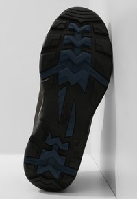 Black rubber shoe sole with zigzag tread, featuring blue accents and textured patterns for enhanced grip and durability.