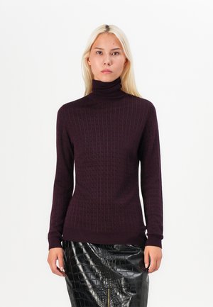 Burgundy turtleneck sweater with ribbed texture and fitted silhouette. Paired with a glossy black crocodile-patterned skirt.