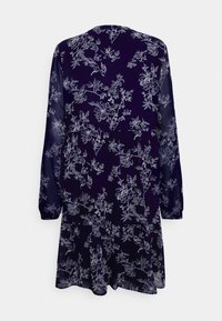 Vestido de manga longa em azul escuro com um padrão floral branco. Feito de tecido leve, apresenta um decote redondo e um corte descontraído.