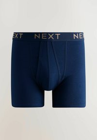 Vyriški šortai tamsiai mėlynos spalvos, aptempanti forma, pagaminti iš lygaus audinio, ant elastingos juostos yra auksinis „NEXT" logotipas.
