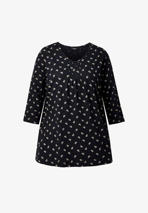 Zwarte tuniek met 3/4 mouwen, voorzien van een subtiel bloemenpatroon in crème. Zachte stof, V-hals en licht uitlopende zoom.