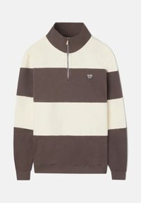 Pull en brown et ivoire à rayures avec un col haut, fermeture éclair mi-zip et logo sur la poitrine. Fabriqué en tissu doux et texturé.