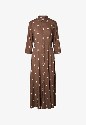 Brun, langermet kjole med hvite polkadotter og knappelukking foran. Laget av lett stoff med krage og midilengde.