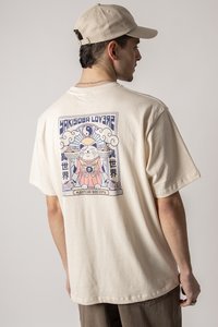 Cream-colored cotton t-shirt featuring a colorful graphic design on the back with a cat holding dishes, accented by cloud motifs.