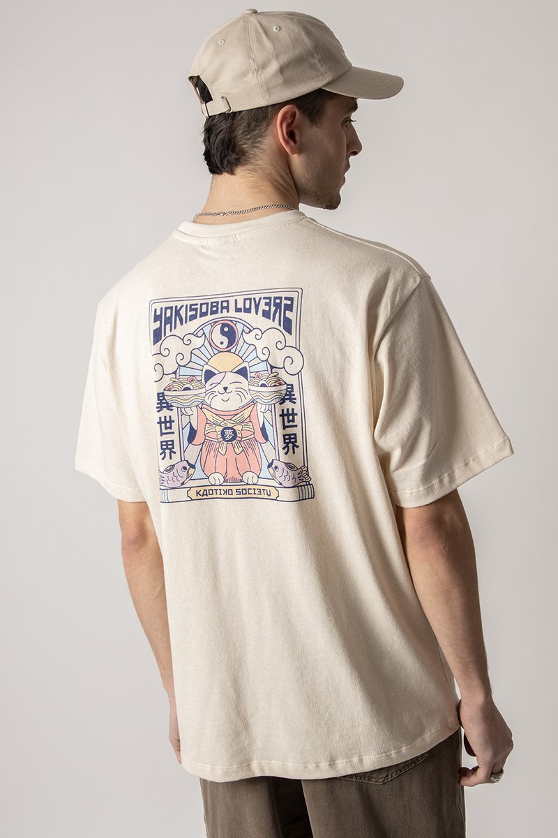 Cream-colored cotton t-shirt featuring a colorful graphic design on the back with a cat holding dishes, accented by cloud motifs.