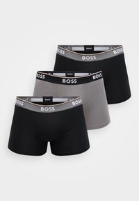 Sada boxerek v černých a šedých tónech. Mají elastické pasy s logem, hladkou látku a přiléhavý střih. Celkem tři páry.