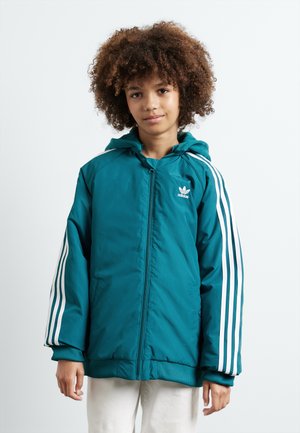 Tirkizna jakna sa zipom i kapuljačom, bijeli trostruki prugasti dizajn na rukavima, rebrasti manžetni i Adidas logo na prsima.