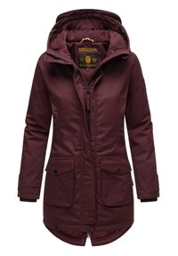 Burgundy parka jacket with a hood, zip closure, two front pockets, and a curved hem. Soft lining and a logo label on the inner collar.