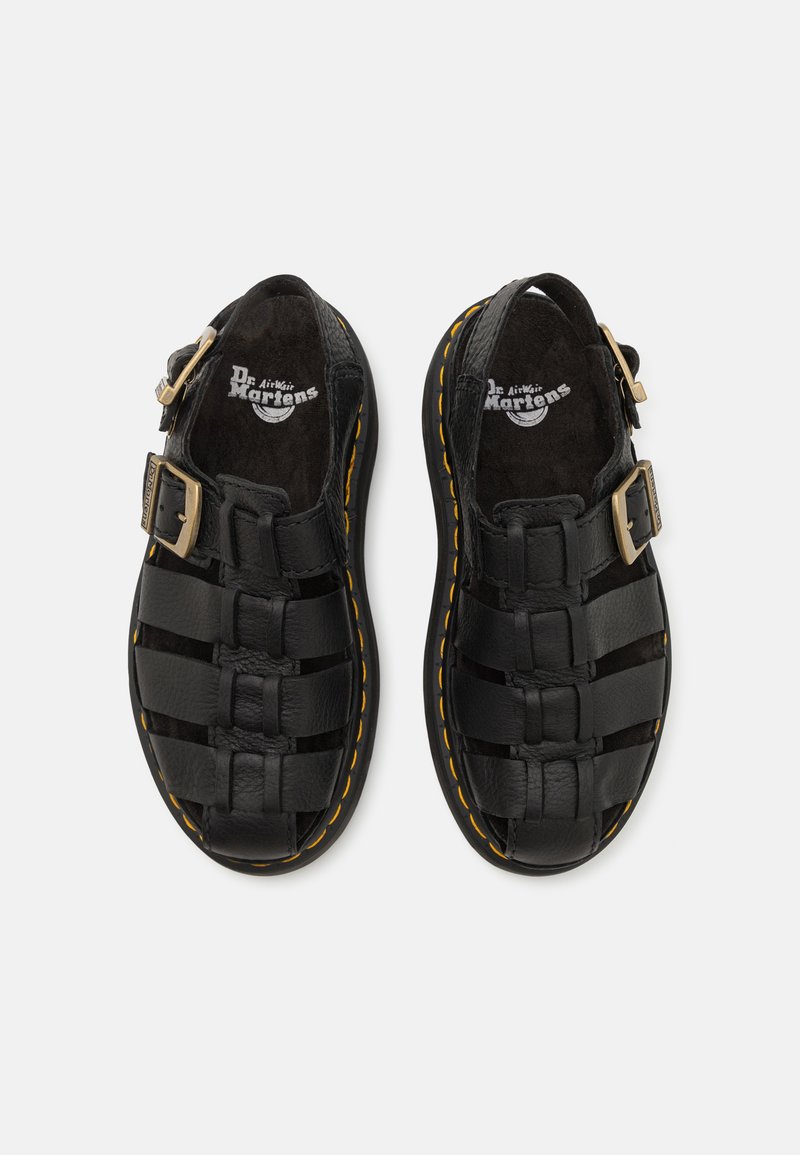Black leather sandals with woven design, buckle closure, and a yellow stitching accent around the sole. Textured footbed for comfort.