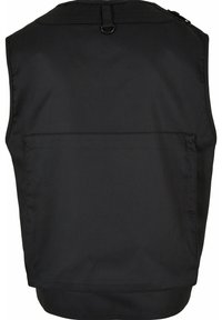 Černá vesta bez rukávů vyrobená z odolné látky, s kapsou na zádech a očkem na zavěšení. Hladká textura s jednoduchým designem.