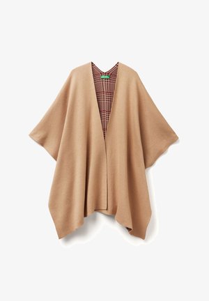 Poncho beige oversize avec un col en V, doté d'un intérieur à carreaux dans des tons rouges et bruns. Tissu doux avec des manches fluides et des côtés ouverts.
