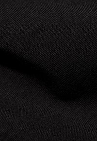 Tessuto nero con una trama fine e testurizzata e una finitura morbida, che mette in risalto la sua superficie liscia e uniforme e la ricca profondità del colore.