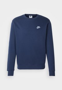 Sweatshirt bleu marine en tissu au toucher lisse. Il a un col rond, des manches longues et un logo Nike blanc sur la poitrine.