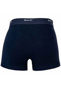 Boxer shorts in cotone blu navy con un elastico in vita marchiato. Presentano una texture liscia e un design a vita media con un piccolo apertura posteriore.