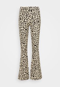 Flared leggings in a light beige fabric with a black leopard print pattern. Features a seamless waistband and a fitted silhouette.