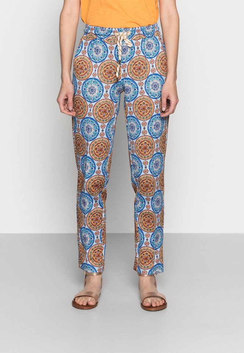 Mönstrade byxor med ett blått och orange cirkulärt motiv på en ljus bakgrund, med resårmidja och snörning.