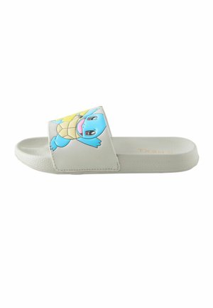 White slide sandal with a blue cartoon turtle character on the strap and textured sole, viewed from the side.