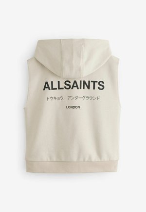 Beige, kapucnis, ujjatlan kapucnis felső, amelynek hátoldalán nagy fekete "ALLSAINTS" felirat található, valamint további japán szöveg és alul a "LONDON" felirat.