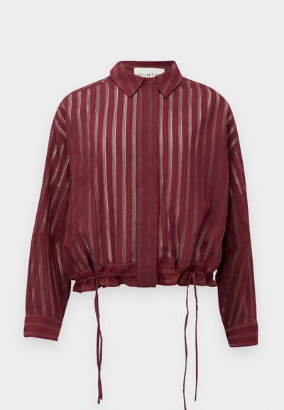 Burgundy sheer blouse with horizontal stripes in varying widths. Features a collar, cuffs, and adjustable drawstring hem for a cropped fit.