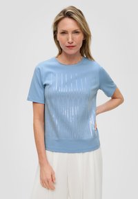 Light blue short-sleeve t-shirt with a sequined vertical stripe design on the front, featuring a round neckline and a solid bottom hem.