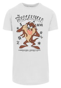 White cotton t-shirt featuring a cartoon character, the Tasmanian Devil, with black and brown accents. Text includes "THE TASMANIAN DEVIL" and Warner Bros logo.
