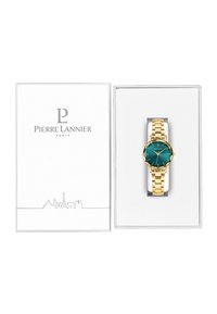 Reloj de pulsera dorado con dial color teal y textura de sol, alojado en una caja clara con la marca "Pierre Lannier Paris" en la tapa.
