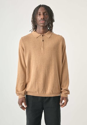 Brown knit pullover with a collared neckline, three buttons, and ribbed cuffs and hem, paired with black pants. Smooth texture.