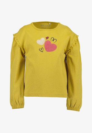 Žlutá košile s dlouhým rukávem a volánkovými akcenty, s grafikou srdíček v bílé, červené a růžové. Bavlněný materiál, uvolněný střih.