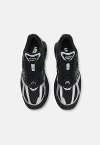 Black mesh athletic shoes with silver accents, featuring a rounded toe, cushioned sole, and lace-up design. Lightweight and breathable materials.