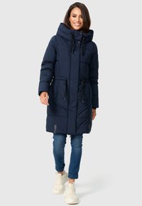 Navy blue puffer coat with a high collar, drawstring waist, and front zipper. Features a quilted design and two logo accents at the hem.