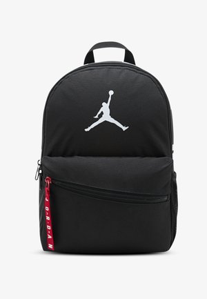 Svart ryggsäck av slitstarkt tyg med vit Jumpman-logotyp, framficka med dragkedja med röd dragflik och justerbara axelremmar.
