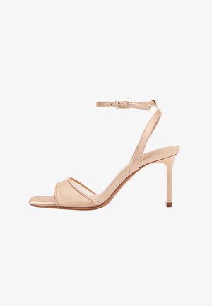 Sandali nudi con tacco alto dal design elegante, cinturino trasparente sulle dita dei piedi, cinturino alla caviglia con fibbia e tacco a spillo sottile.