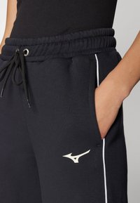 Mizuno ATHLETICS PANT - Treniņtērpa apakšdaļas - black