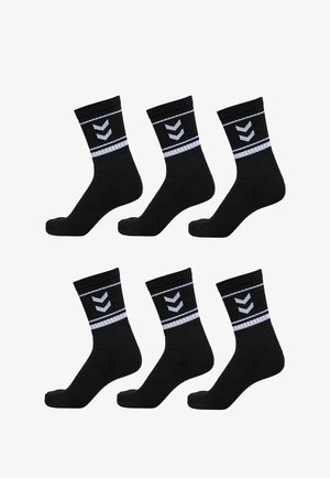 Black cotton socks with a ribbed cuff, featuring white chevron patterns and stripes. Pack of six socks arranged in two rows.