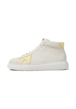 High-top sneakers made of white leather with a yellow accent, flat white sole, and red logo tag. Features smooth texture and minimal design.