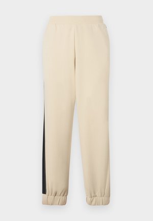 Cremefarvede sweatpants med sorte sidebaner, elastisk talje og ribbede manchetter. Blødt stof med en afslappet pasform.