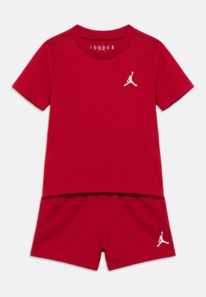 Red cotton short-sleeve T-shirt and shorts set, featuring a white Jumpman logo on both the top and bottom. Smooth texture, casual fit.