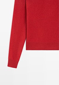 Maglione rosso con maniche lunghe, realizzato in tessuto morbido, con orlo e polsini a coste, texture liscia e design semplice.