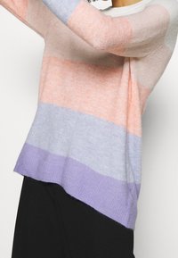 Lightweight sweater with color-blocked stripes in peach, pink, blue, and lavender, featuring a relaxed fit and crew neckline.